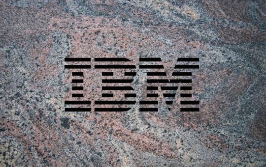 IBM logo on a granite background to illustrate the launch of the company's Granite 3.0 family of AI models alongside an open-source commitment.