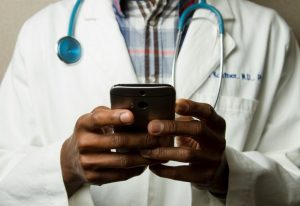 Doctor using an app on a smartphone device as healthcare regulator MHRA is fast-tracking new AI tools that promise to dramatically improve patient care.
